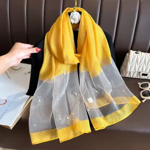 Elegant yellow and white sheer scarf featuring delicate beaded floral patterns for women.