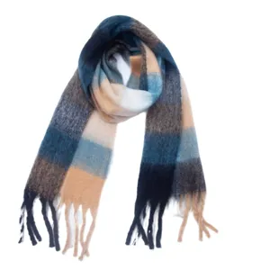 Close-up detail of a soft cozy plaid tassel scarf with blue and camel gradient colors.
