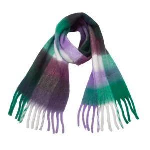 Close-up of a soft and cozy green purple plaid scarf with stylish fringe details.