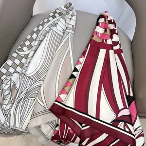 Detailed view of luxury geometric printed twill silk scarf, versatile hair band and neck accessory.
