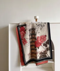 Close-up detail of vintage Leaning Tower of Pisa and red rose jacquard woven throw blanket.