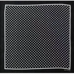 Detail shot of black cotton square scarf featuring classic white polka dots and neat borders.
