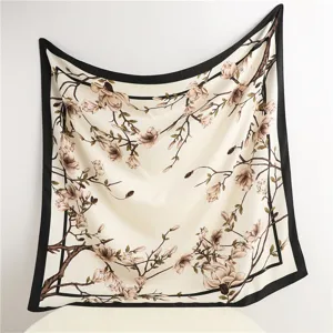 Elegant floral print silk square scarf detail, vintage branch design with stylish black border.