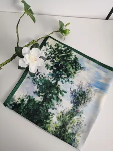 Close-up detail of the square oil painting silk scarf featuring impressionist landscape and green border.