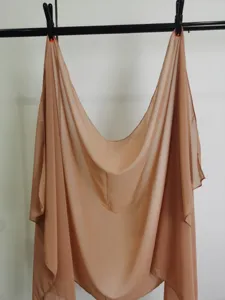 Detail shot of solid color chiffon shawl hanging cleanly, lightweight and breathable fabric.