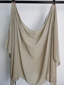 Solid color chiffon scarf detail hanging naturally, lightweight and breathable fabric texture.