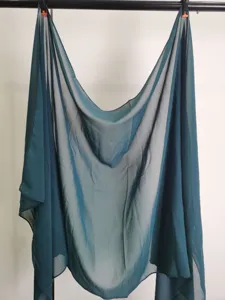 Solid color chiffon scarf detail shot, lightweight and breathable fabric in dark teal tone.