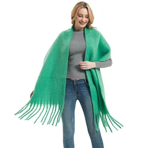 Bright green knitted fringed scarf detail, soft texture and stylish autumn winter shawl design.