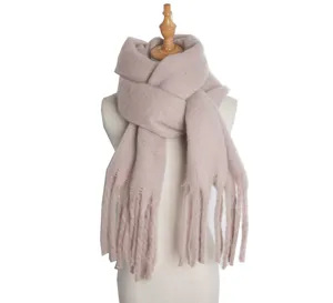 Close-up detail of soft fluffy knit winter scarf with fringe, elegant cozy texture.