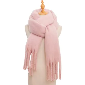 Pink fluffy tassel scarf detail shot, soft plush winter accessory close-up view design.
