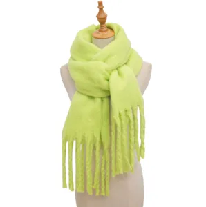 Detailed view of women neon green fuzzy winter scarf with fringe, soft knit texture.