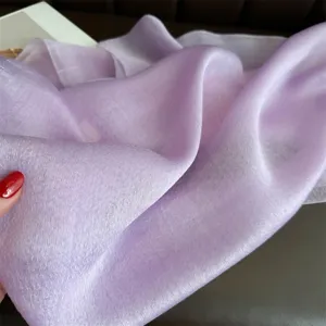 Light purple silk wool shawl close up, elegant soft draped fabric for luxury winter wear.