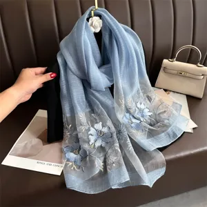 Blue silk wool embroidered scarf detail showcasing exquisite floral craftsmanship and drape.