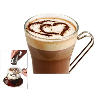 Detail view of coffee latte art stencil and shaker in use, creating beautiful cocoa patterns.