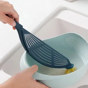 Multifunctional rice washing spoon and colander tool for daily kitchen food draining.