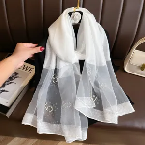 Elegant white sheer scarf with pearl and rhinestone floral embellishments, perfect for women.