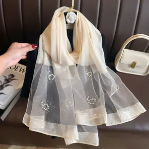 Beige sheer mesh silk scarf detail with pearl and rhinestone floral embellishments elegant wrap.