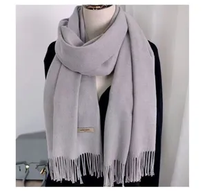 Detail shot of light grey cashmere feel tassel scarf elegant autumn winter warmth accessory