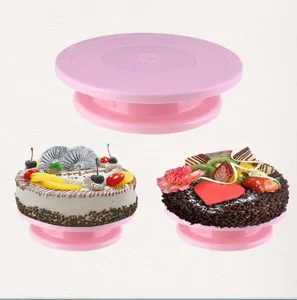 Pink plastic cake turntable rotating stand with non-slip base for baking and decorating.
