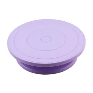 Purple plastic cake turntable rotating stand with non-slip base for baking and decorating.