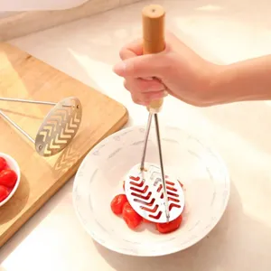 Stainless steel potato masher with wooden handle, durable kitchen tool for mashing fruit food.