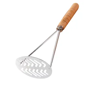 Stainless steel potato masher with wooden handle kitchen tool for mashing sweet potatoes.