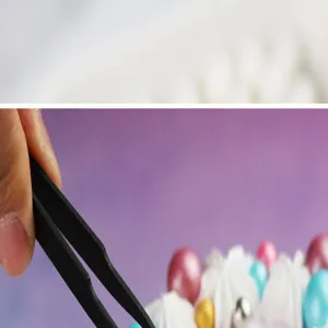 Detail view of black stainless steel fine pointed precision tweezers for baking decorating beads.