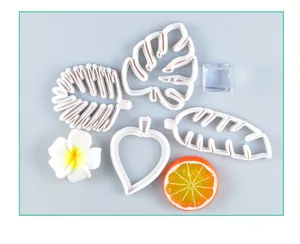 Tropical leaf cookie cutters detail view, white plastic mold set for DIY baking design.