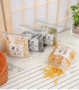 Detail view of transparent food storage ziplock bags filled with beans and pasta.