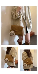 Retro deerskin velvet shoulder bag detail view featuring chic metal lock and cute bunny plush charm.