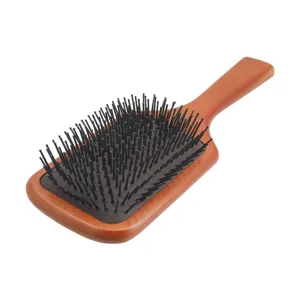 Spazzola per capelli piatta in legno con cuscino da massaggio per la cura quotidiana.