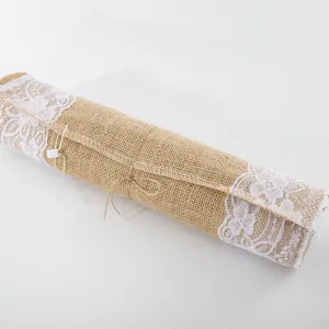 Detailed view of rolled natural burlap table runner decorated with elegant white lace edge.