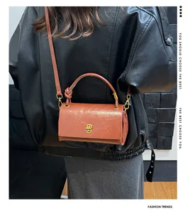 Stylish women's minimalist brown leather shoulder crossbody bag with metal lock detail.