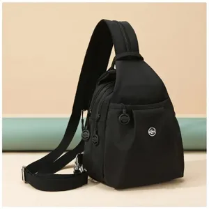 Black casual nylon sling backpack, minimalist commuter daypack with front pocket details.