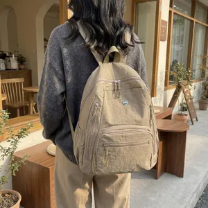 Casual minimalist nylon backpack for women, stylish everyday commuter daypack in khaki.