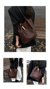 Dark brown woven leather tote shoulder bag for women, vintage bucket bag with beaded charm.