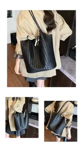 Details of black woven leather tote bag, stylish shoulder bucket bag for daily commuting.