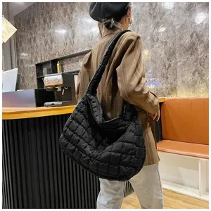 Fashionable black quilted cloud bag, large capacity puffy shoulder tote for women.