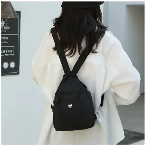 Detail view of Japanese style minimalist black drawstring backpack for casual daily commute.