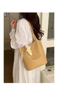 Large capacity woven tote bag for women, chic commuter shoulder bag with cute bear pendant and tassel.
