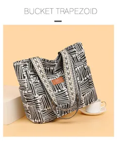 Detailed view of black and white canvas tote bag featuring unique ethnic straps and large capacity.