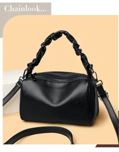 Stylish black leather pillow shoulder bag with gathered handle and dual zippers for women.