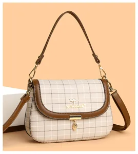Retro plaid shoulder bag for women, elegant commuter crossbody bag with chic design and strap.
