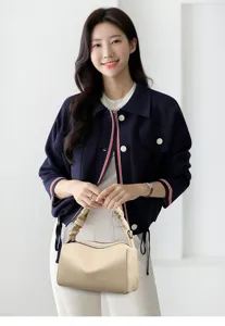 Elegant beige pillow crossbody bag with pleated handle and dual zippers for women.