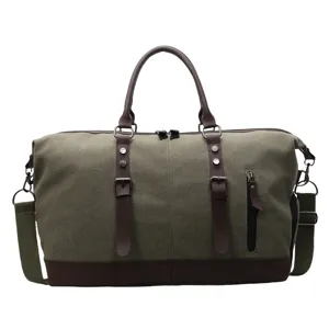 Grand sac de voyage en toile avec finitions en cuir marron, parfait pour les voyages d'affaires.