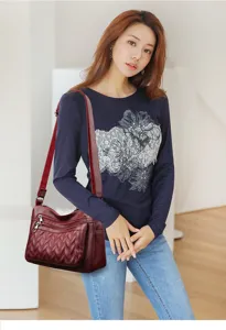 Detail view of the soft leather woman shoulder bag with multi pocket design and elegant quilting.