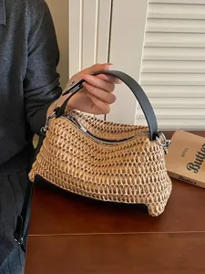 Woven straw shoulder bag with black leather handle and trim, chic summer casual handbag.