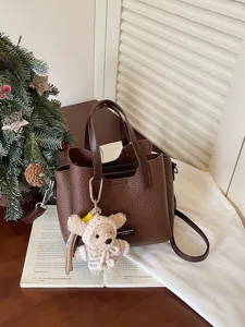 Brown pebbled leather tote bag with cute crochet bear pendant and adjustable crossbody strap