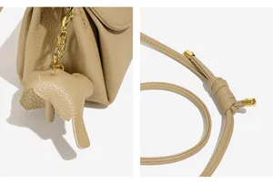 Detail view of minimalist vintage women leather crossbody bag with cute elephant charm.