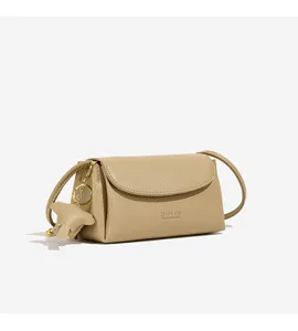 Detailed view of casual leather crossbody shoulder bag showing fine texture and cute pendant.